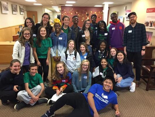 This is a group photo of students smiling at the camera at a Seeds of Peace training session.