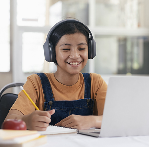 Child similing at desk