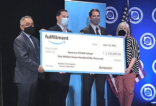 Amazon check presentation to local leaders; from left to right: Syracuse City Schools Superintendent Jaime Alicea, Onondaga County Executive Ryan McMahon, Syracuse Mayor Ben Walsh, Syracuse Common Councilor At-Large Rita Paniagua