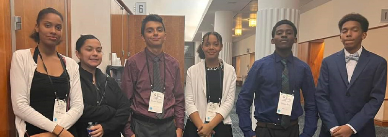 six nicely dressed students standing next to each other