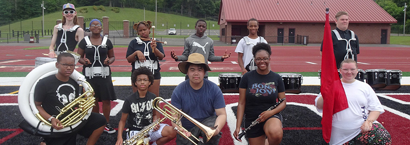 marching band students standing next to each other on a field